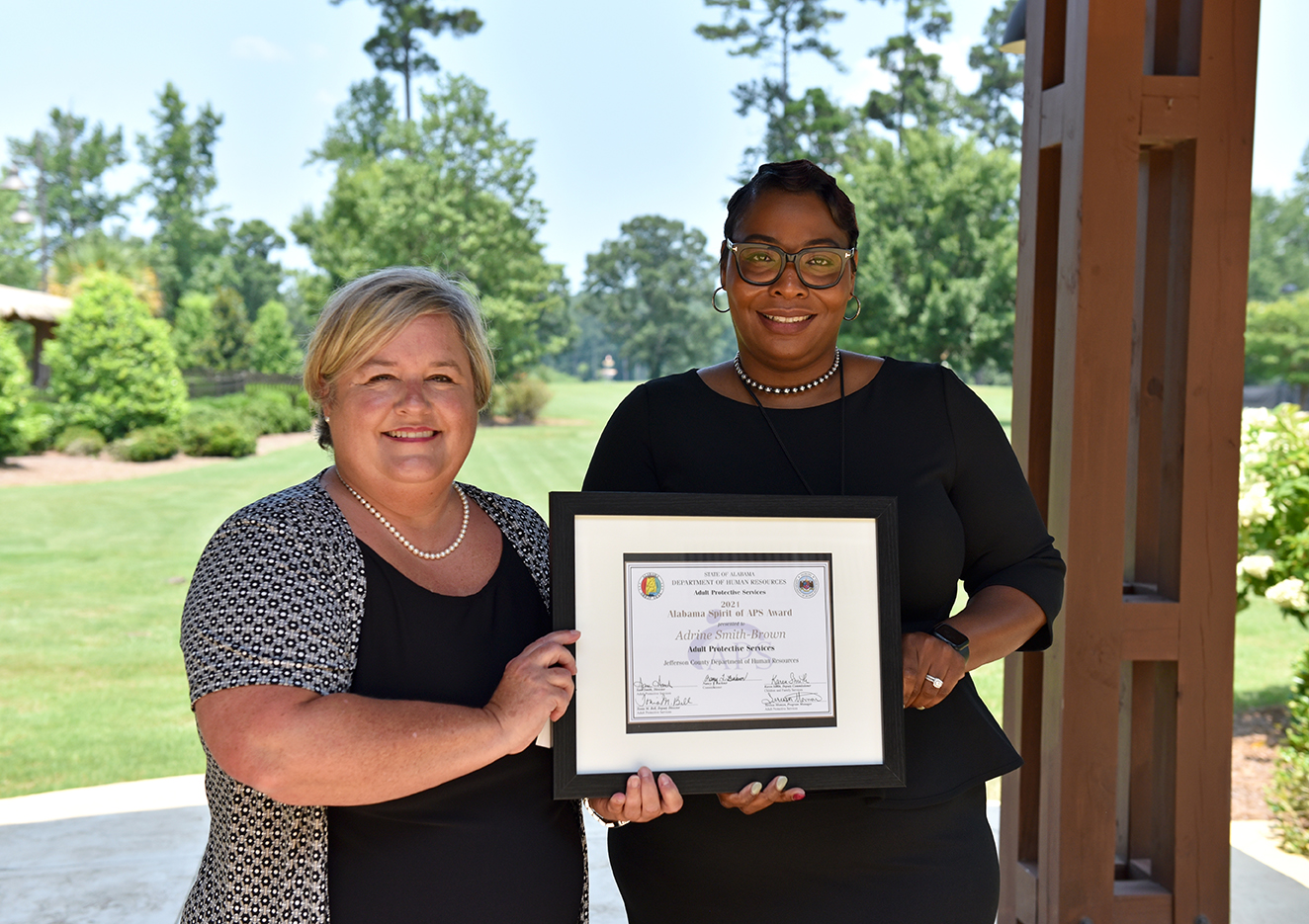 Alabama DHR Deputy Commissioner Karen Smith presents the 2021 Spirit of APS Award to Adrine Smith-Brown at the Adult Protective Services Legal Conference in Opelika.